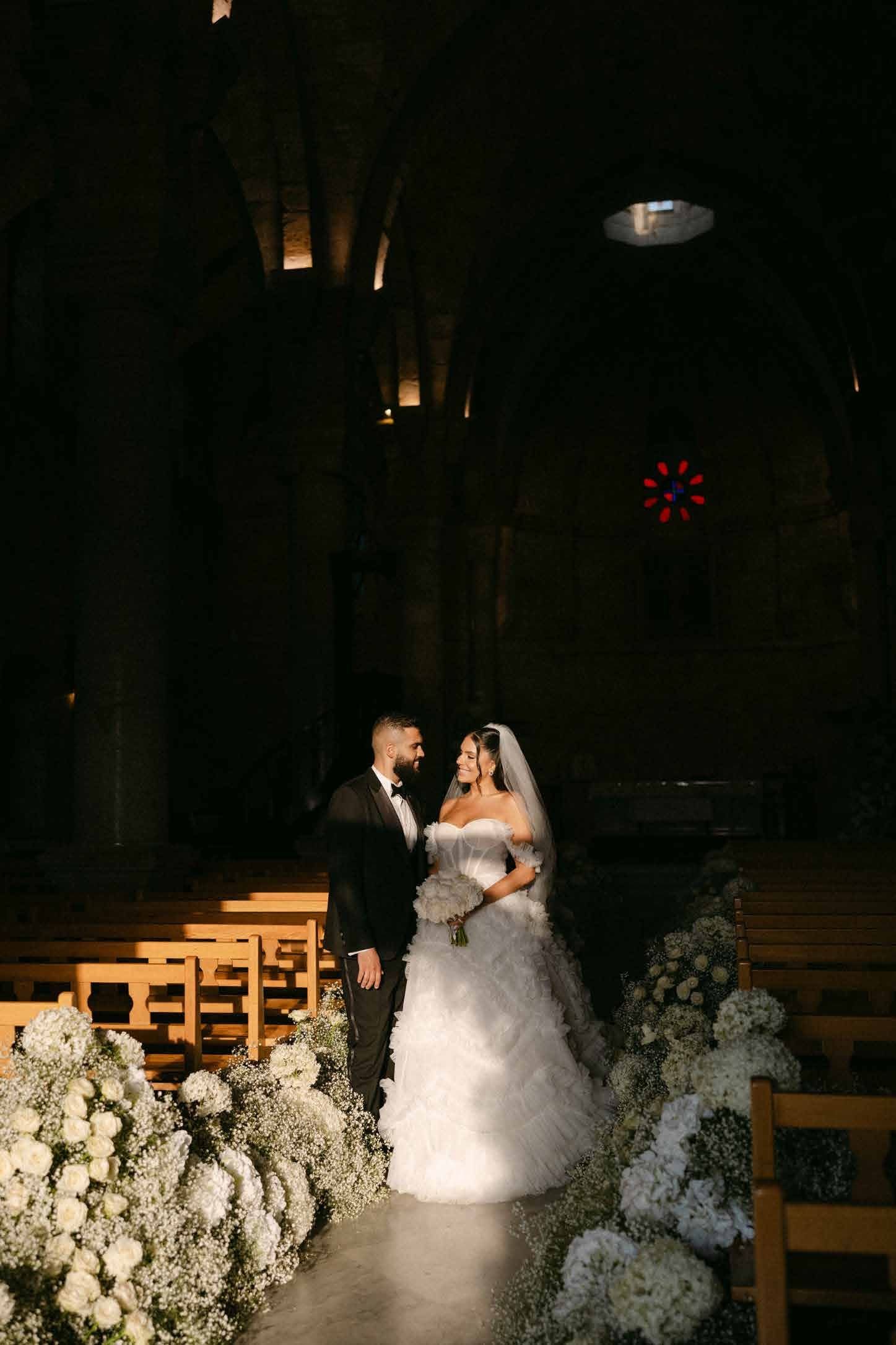 Couple portrait inside the candlelit stone church