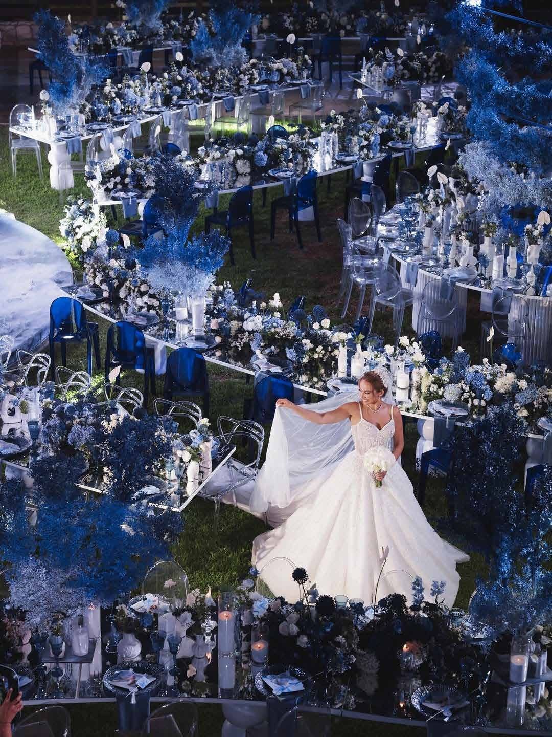 Aerial view of the bride on the illuminated blue reception floor