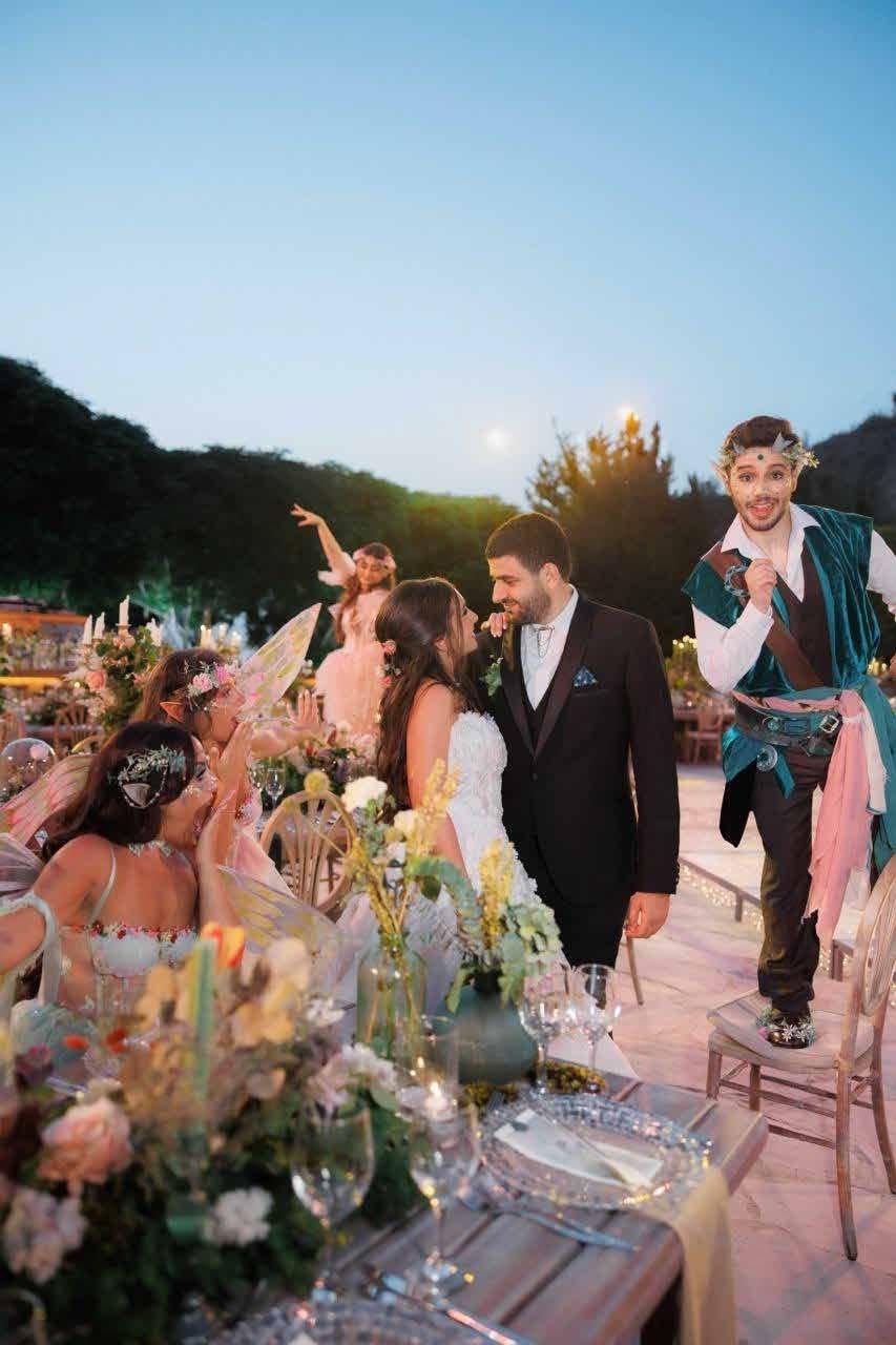 Costumed wedding party at dusk in the garden