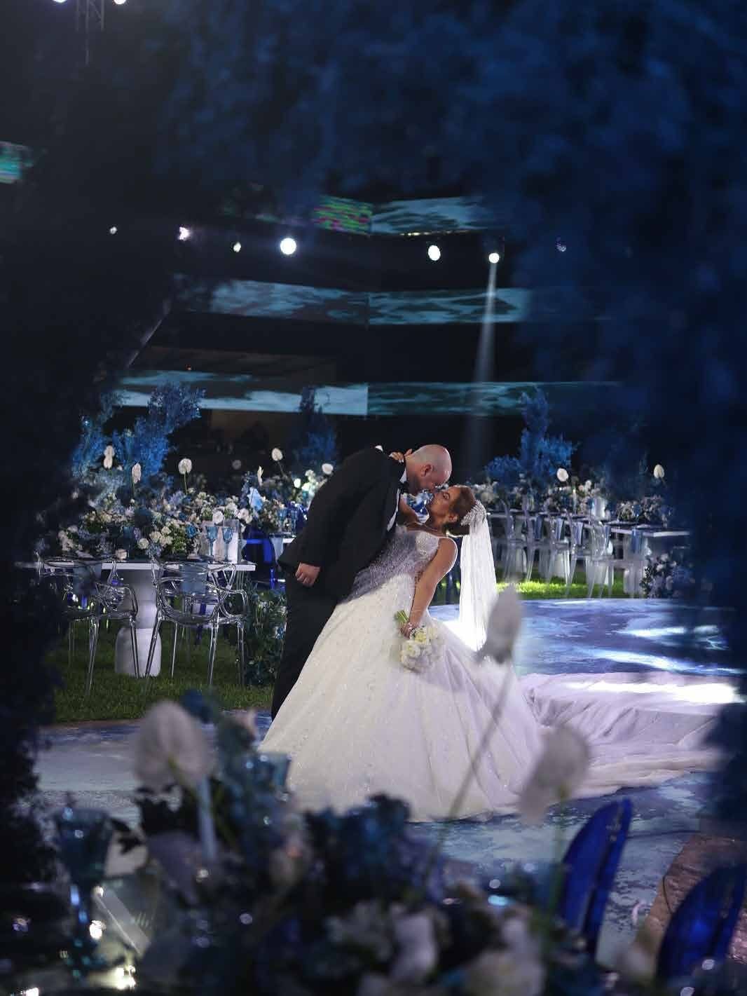 Couple walking across the illuminated dance floor