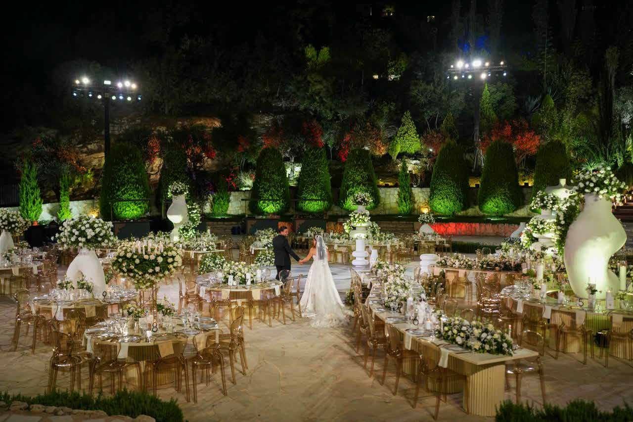 Bride's reflection as a bridesmaid helps with her gown